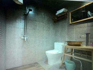 a bathroom with a toilet and a sink and a shower at Flowers Residence in Yuanyang