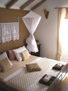a bedroom with a bed with two towels on it at Charming dalmatian apartment with panoramic view in Tkon
