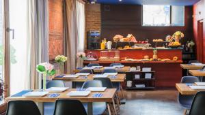 a restaurant with wooden tables and chairs and a counter at Apartamentos Abad Toledo in Toledo