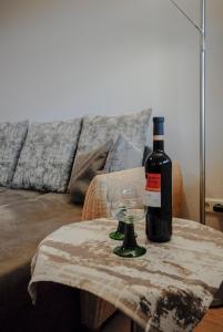 a bottle of wine sitting on a table with a glass at Ferienwohnung Alte Hofmark Neumayer in Bad Birnbach