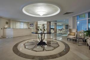 a large lobby with a table in the middle at Fraser Suites Abuja in Abuja