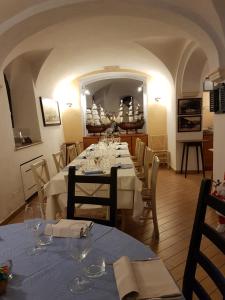 a dining room with a long table with white tables and chairs at Hotel Argentina in Santa Margherita Ligure