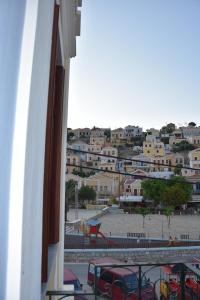 a view of a city from the balcony of a building at Myrtia in Symi +99 photos