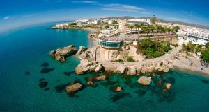 an aerial view of a beach with rocks in the water at Hotel Plaza Cavana in Nerja