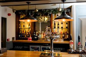 a bar with bottles of alcohol on a shelf at The Saracens Head in Stafford