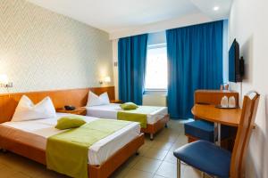 Postel nebo postele na pokoji v ubytování Hotel Apollo