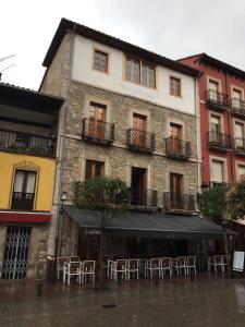 a building with tables and chairs on a flooded street at pensionsanpelayo10 in Cangas de Onís