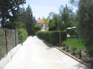 a driveway leading to a house with a fence at Zena Holiday Villa in Pissouri