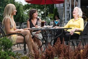 three women sitting at a table with glasses of wine at Shaw Club Hotel in Niagara on the Lake