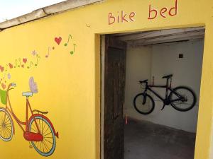 a yellow building with two bikes on the wall at Barone 4 You in Šibenik