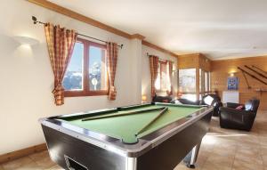 a living room with a pool table in it at Résidence Odalys Les Belles Roches in Notre-Dame-de-Bellecombe