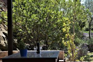 a table with a bottle and two glasses on it at Marvelous Sea View Eco Apt in Ammouliani