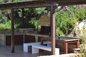 a patio with a table and a bench and a gazebo at Marvelous Sea View Eco Apt in Ammouliani