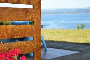 a table and a chair and some flowers and the water at Marvelous Sea View Eco Apt in Ammouliani
