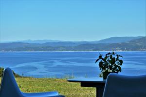 a table and chairs with a view of the water at Marvelous Sea View Eco Apt in Ammouliani