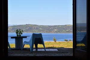 a white chair sitting in front of a table at Marvelous Sea View Eco Apt in Ammouliani