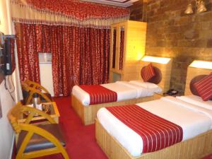 Postel nebo postele na pokoji v ubytování Hotel Lal's Haveli