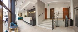 a lobby of a store with a staircase and chairs at Hotel Alexander in Krakow