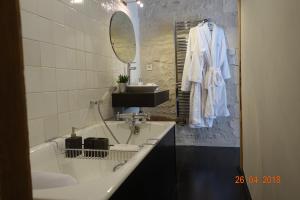 a white bathroom with a sink and a mirror at Les Clés d'Ars in Ars-en-Ré