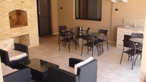a restaurant with tables and chairs and a fireplace at Vila Ando Mamaia Nord in Mamaia Sat/Năvodari