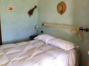 Ένα ή περισσότερα κρεβάτια σε δωμάτιο στο Agriturismo La Rocca di Perti