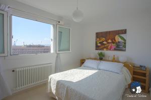 a bedroom with a bed and a large window at Spacious 2 bedroom near city centre - Dodo et Tartine in Toulon