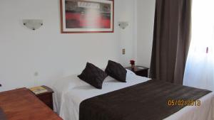 Ένα ή περισσότερα κρεβάτια σε δωμάτιο στο Hotel Real