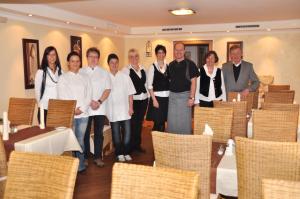 a group of people standing in a room with chairs at Hotel Flurschütz in Lennestadt