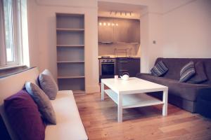 a living room with a couch and a table at Flat1 Camden Road in London