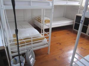 a small room with a bed and a bunk bed at Hostel Prime Guimaraes in Guimarães