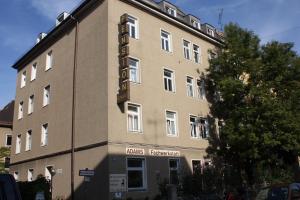 a building with a sign on the side of it at Hotel Pension Schmellergarten in Munich