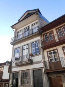 a tall building with balconies on the side of it at Hostel Prime Guimaraes in Guimarães