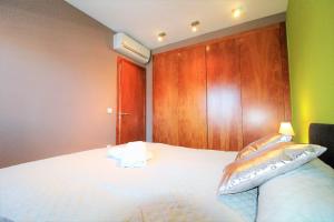 a bedroom with a bed with a fish pillow on it at Marina Beach Hollidays Mimosa in Empuriabrava +23 photos