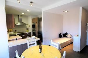 a kitchen and a bedroom with a bed and a table at Marina Beach Hollidays Mimosa in Empuriabrava