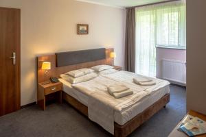 Postel nebo postele na pokoji v ubytování Maximus Spa