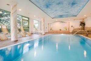 a swimming pool in a house with a ceiling at Sporthotel St. Michael in Malles Venosta