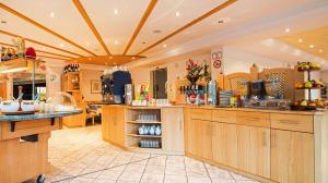 a large kitchen with wooden cabinets and counters at Sporthotel St. Michael in Malles Venosta