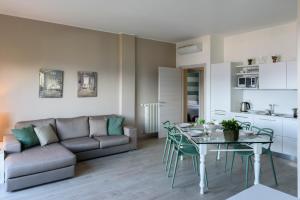 a living room with a couch and a table at Residence Le Primule in Stresa