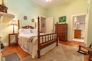 a bedroom with a bed and a dresser in a room at Riverboat Bed & Breakfast in Natchez