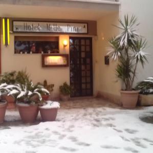 a hotel with potted plants in front of a door at MillePini in Calatafimi