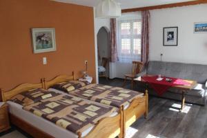 a bedroom with a bed and a couch and a table at Hotel "Fränkischer Hof" Garni in Dinkelsbühl