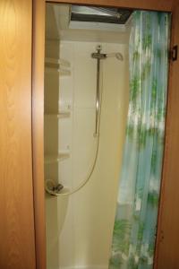 y baño con ducha y cortina de ducha. en Camping Parco Capraro, en Lido di Jesolo