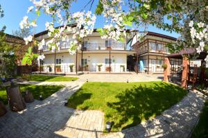 a building with a lawn in front of it at Sovenok Apart-Hotel in Yeysk