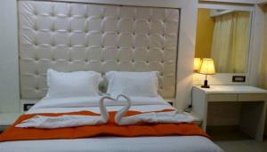Postel nebo postele na pokoji v ubytování Setrac Orange Hotel
