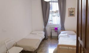 A bed or beds in a room at Between Termini & Colosseo