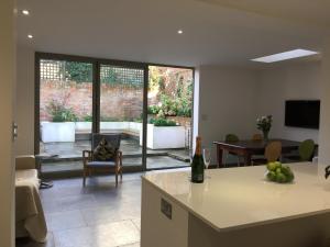 a kitchen and living room with a view of a patio at Jorvik Lodge in York