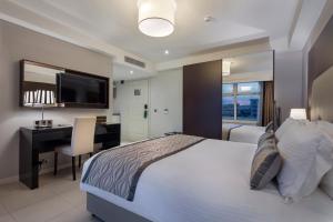 Postel nebo postele na pokoji v ubytování Fraser Suites Abuja