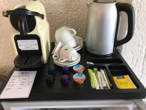 a counter with a coffee maker and a tea kettle at Sailor's Nautical Concept in Spetses
