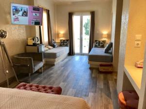 a living room with two beds and a tv at Sailor's Nautical Concept in Spetses