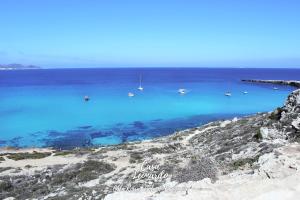 a view of a beach with boats in the water at Casa Leonardo in Favignana